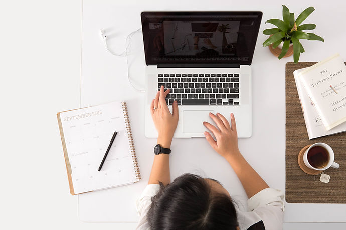 Laptop and paperwork on a bright desk